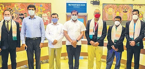 The awardees with Sports Minister Tusharkanti Behera at Lok Seva Bhawan in Bhubaneswar on Sunday | Express