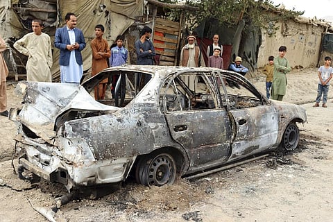 Locals view a vehicle damaged by a rocket attack in Kabul, Afghanistan, Monday, Aug. 30, 2021. (Photo | AP)