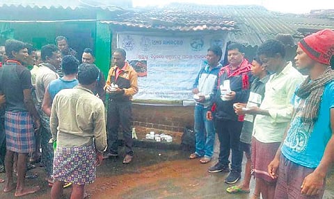 Veterinary staff of Koraput with locals of Phagun Senari village during a camp. (Photo | Express)