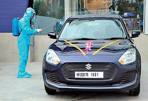 A car being sanitised before delivery at a Maruti Suzuki India showroom | Express