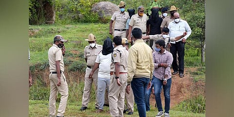 Police take the accused arrested in the Mysuru gangrape case to the scene of crime at the Chamundi foothills in Mysuru on Monday | Udayshankar S