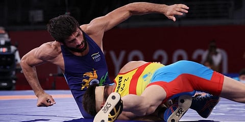 Kazakhstan's Nurislam Sanayev (R) wrestles India's Kumar Ravi in their men's freestyle 57kg wrestling semi-final match during the 2020 Olympics at the Makuhari Messe in Tokyo. (Photo | AFP)