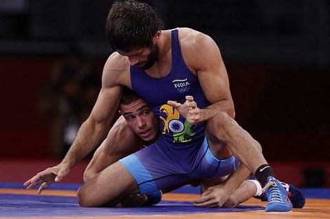 Bulgaria's Georgi Valentinov Vangelov (red) wrestles India's Kumar Ravi in their women's freestyle 57kg wrestling quarter final match during the Tokyo 2020 Olympic Games. (Photo | AFP)