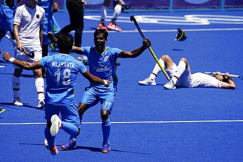 India's Nilakanta Sharma (18) and Sumit (17) celebrate as Germany's Lukas Windfeder, right, reacts after India won their men's field hockey bronze medal match. (Photo | AP)