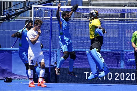 India goalkeeper Sreejesh Parattu Raveendran, center, celebrates after making a save as Germany's Benedikt Furk, second from left, looks on. (Photo | AP)
