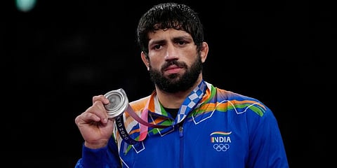 India's silver medalist Ravi Dahiya celebrates on the podium for the men's 57kg Freestyle wrestling, at the 2020 Summer Olympics in Tokyo, Japan. (Photo | AP)
