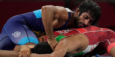 India's Bajrang Bajrang, top, competes against Iran's Morteza Ghiasi Cheka during their men's freestyle 65kg wrestling match at the 2020 Summer Olympics in Chiba, Japan. (Photo | AP)