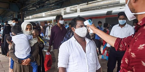 Health officials check thermal temperature at Dadar railway station on Thursday. (Photo | PTI)