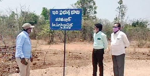 Revenue Department staff erect signboards at Achampet village. (File photo | Express)