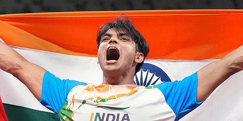 India's Neeraj Chopra holds the Tricolor after winning gold in the final of the men's javelin throw event at the 2020 Tokyo Olympics. (Photo | PTI)