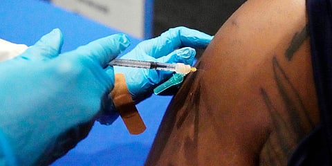 A senior at Jackson State University and defensive lineman with the school's football team, receives his COVID-19 vaccination. (File photo| AP)