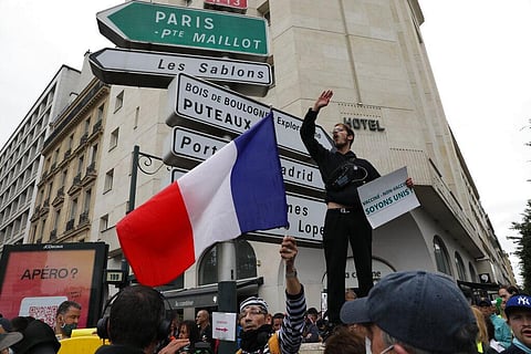 Anti-Vax protesters gather to protest against the vaccine and the vaccine passport, during a demonstration in Paris. (Photo | AP)