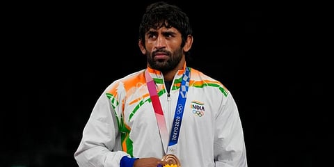 India's Bajrang Punia strands on the podium with his bronze medal. (Photo | AP)