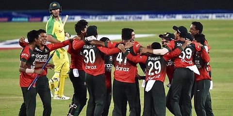 Australia's Daniel Christian walks off the field as Bangladesh cricketers celebrate after winning the third Twenty20 international cricket match. (Photo | AFP)