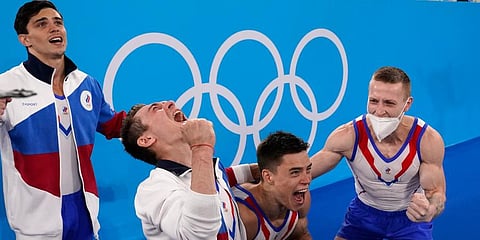 ROC's artistic gymnastics team, from right, Denis Abliazin (R), Nikita Nagornyy, David Belyavskiy & Artur Dalaloyan celebrate after winning the gold medal at the 2020 Olympics. (Photo | AP)
