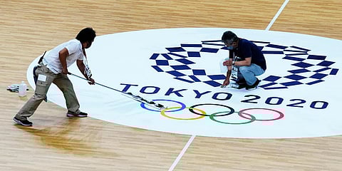 Workers clean the handball court at the Yoyogi National Stadium during the 2020 Olympics in Tokyo. (File photo| AP)