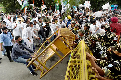 Congress activists try to remove the barricades during a protest in support of party leader Rahul Gandhi against the 'temporary suspension' on his Twitter account. (Photo | PTI)