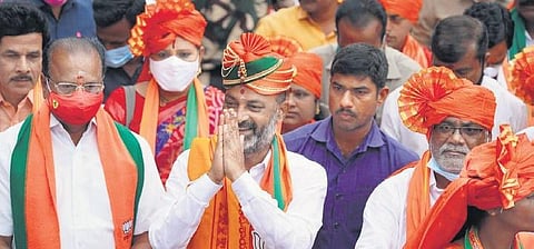 BJP State president Bandi Sanjay greets people on the fourth day of his Praja Sangrama Yatra at Chilkur X roads on Tuesday. (Photo | Express)