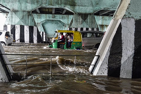 ehicles ply on the waterlogged Bahadur Shah Zafar Marg after heavy rain at ITO in New Delhi on Wednesday. (Photo | PTI)
