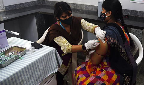 A health worker administers Covid vaccine to a woman in Bengaluru on Tuesday | Express
