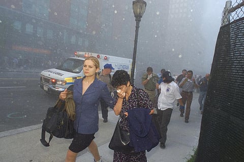 People flee from downtown Manhattan after planes crashed into the twin towers of the World Trade Center on September 11, 2001. (Photo | AP)