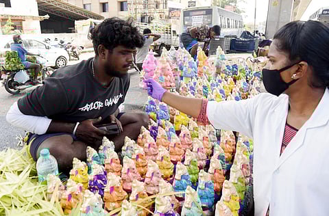 Health worker collects test sample to detect Covid-19 during the Vinayagr idol sales. (Photo | R Satish Babu, ENS)