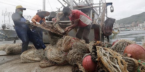 Fishermen organize fishing nets to take shelter as Typhoon Chanthu approaches to Taiwan in Keelung, New Taipei City, Taiwan, Saturday, Sept. 11, 2021. (Photo | AP)