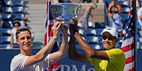 Briton, Joe Salisbury (L), and teammate Rajeev Ram, of the United States, hold their US Open men's doubles trophy after defeating Brazilian Bruno Soares, and Briton Jamie Murray. (Photo | AP)