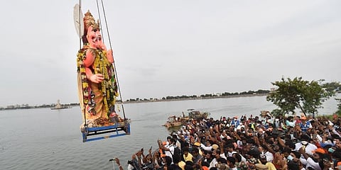 Devotees capture the moment on their mobile phones as the Khairtabad Ganesh idol is immersed in Hussainsagar at Tank Bund. (File Photo | EPS)
