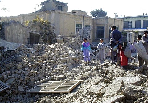 Afghans look at the debris of a destroyed house in Kabul, Afghanistan after heavy U.S. led military strikes. (Photo | AP)