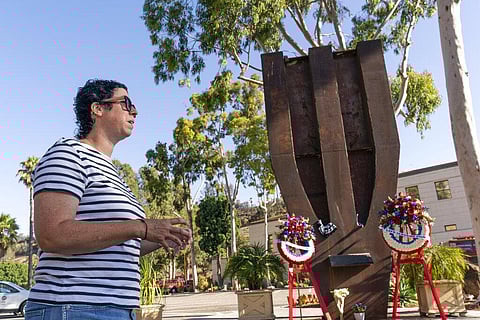 New Yorker Suzanne Clemmer brings flowers to the World Trade Center Memorial to commemorate the 20th anniversary of the Sept. 11 terrorist attacks. (Photo | AP)