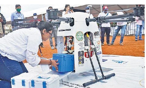 An expert placing a medicine case inside a drone, as part of the ‘Medicine from the Sky’ project, at Vikarabad on Saturday; the drone on the way to its destination — a health centre