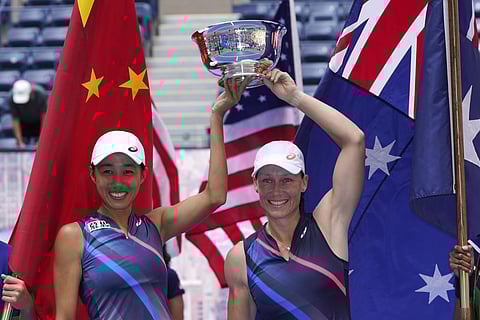 Shual Zhang, of China, left, and Samatha Stosur, of Australia, hold the championship trophy after defeating Coco Gauff and Catherine McNally during the women's doubles final. (Photo | AP)