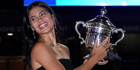 Emma Raducanu poses outside Arthur Ashe Stadium with the championship trophy after she defeated Leylah Fernandez in the women's singles final of the US Open tennis championships. (Photo | AP)