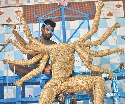 An artisan busy making an idol of Goddess Durga at a pandal in Cuttack | Express