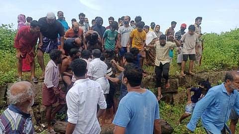 Residents gather around the three fishermen rescued by Babeesh Balakrishnan, at Keezhur in Kasaragod on Sunday. (Photo | EPS)