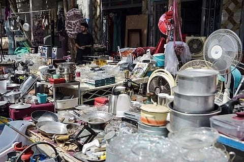 This photo taken on September 12, 2021 shows shopkeepers displaying secondhand household items for sale at a market in the northwest neighbourhood of Khair Khana in Kabul. (Photo | AFP)