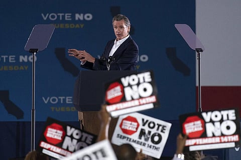 Supporters hold up signs as California Gov. Gavin Newsom speaks at a rally ahead of the California gubernatorial recall election. (Photo | AP)