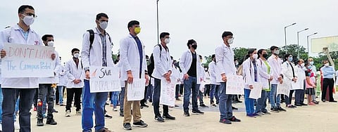 Faculty and students of UCMS stage a protest at the campus on Monday. (Photo | EPS)