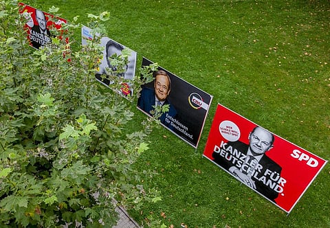 Election posters of Social Democratic candidate Olaf Scholz, right, and candidate of Christian Democrats Armin Laschet, second right, are displayed in Frankfurt. (Photo | AP)