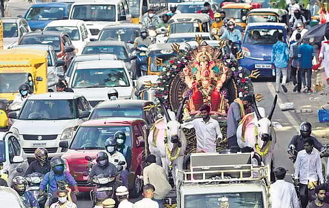 A Ganesh idol being taken for immersion on a bullock cart, is stuck in traffic at NTR Marg, on Wednesday. (Photo | Vinay Madapu)