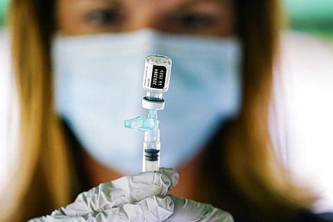 A syringe is prepared with the Pfizer COVID-19 vaccine at a clinic at the Reading Area Community College in Reading. (Photo | AP)