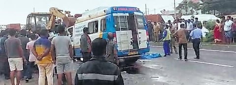 A video grab shows an earth-moving vehicle attempting to clear debris from the accident scene, in Bengaluru on Thursday. The ill-fated ambulance is also seen