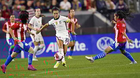 U.S. forward Carli Lloyd, center, moves the ball past Paraguay midfielders during an international friendly match on Thursday, in Cleveland. (Photo | AP)