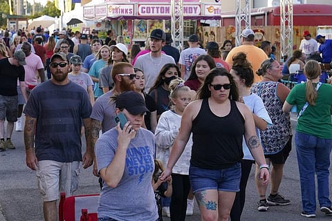 People walk through the food truck area on the opening day of the Oklahoma State Fair. (Photo | AP)