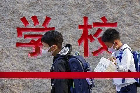 In this Sept. 7, 2020 file photo, students wearing face masks to help curb the spread of the coronavirus walk in line as they arrive at a primary school in Beijing. (Photo | AP)