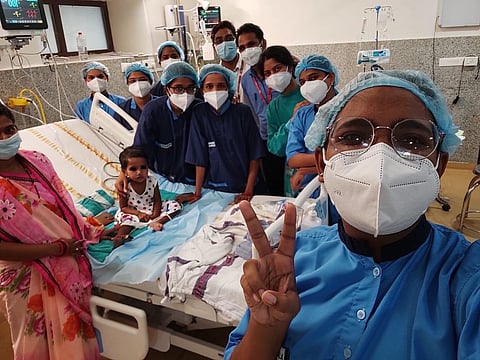 The girl child with the treating doctors of AIIMS-Bhubaneswar on Saturday. (Photo | Express)