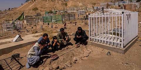 Ahmadi family pray at the cemetery next to family graves of family members killed by a US drone strike. (File Photo | AP)