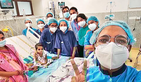 The girl with the treating doctors of AIIMS-Bhubaneswar. (Photo| EPS)