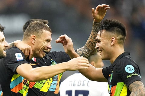Inter Milan's Edin Dzeko, left, celebrates after scoring with teammate Lautaro Martinez during Serie A match against Bologna, at San Siro stadium in Milan, Italy, Saturday. (Photo | AP)